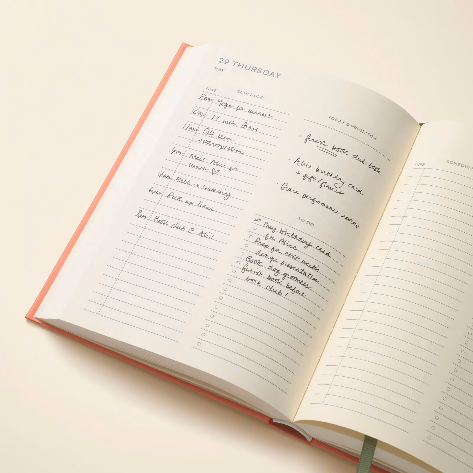 A product photo for Papier's hardcover daily planner showing Thursday, May 29. The left column is a schedule, the right column is today's priorities and a to do list.